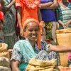 Ethiopian woman selling crops in a local crowded market