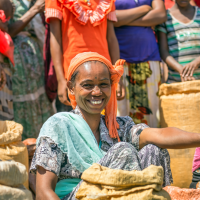 Ethiopian woman selling crops in a local crowded market
